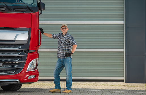 Professional Euro Trucker and His Brand New Semi Tractor Truck. Heavy Duty Transportation Industry.