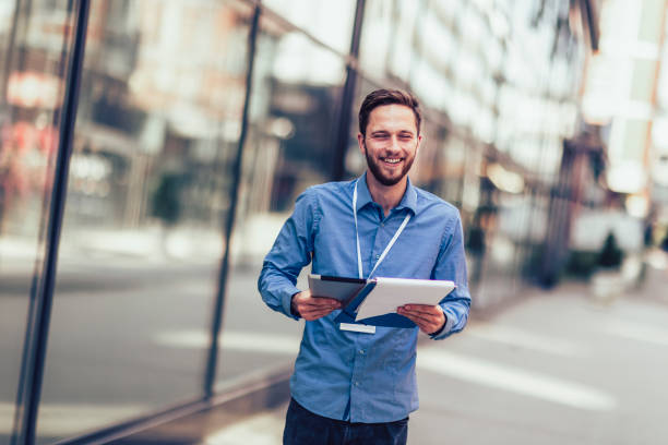 istock Businessman is outside and he has to work so he is using digital tablet 1550839934