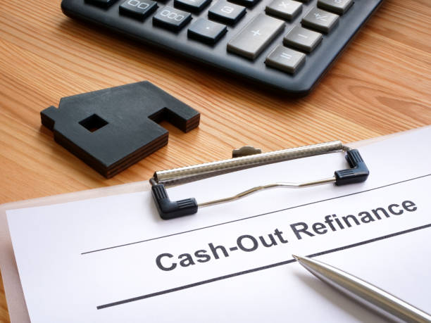 istock Application for cash out refinance and model of house. 1550868145