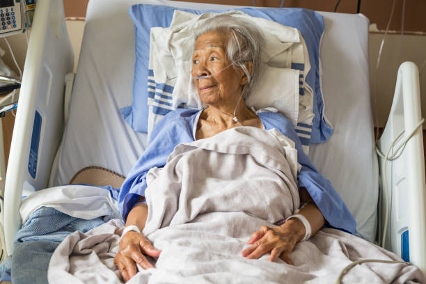 Elderly Filipino senior woman receiving  oxygen at a hospital and recovering well with the treatment.