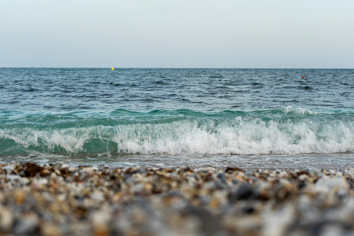 image of the sea waves breaking on the shore of the beach