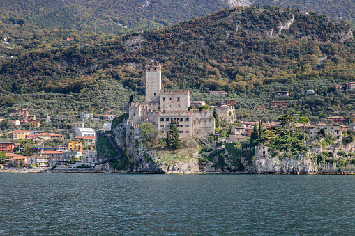 View of fortress, old town, mountains and lake Garda in Malcesine, Italy