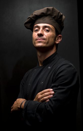 High Class european Chef posing on black background