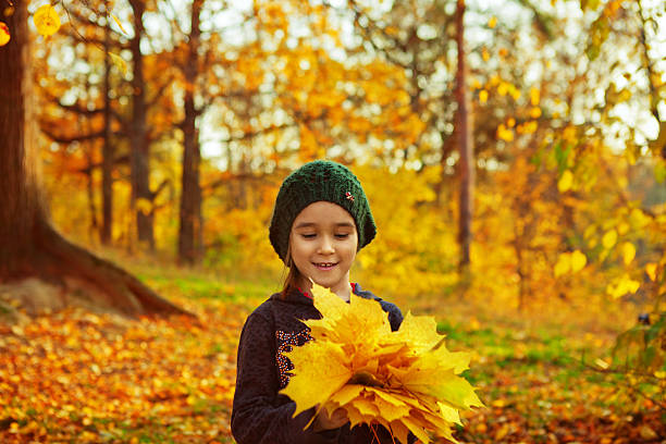 Little girl with autumn leafs