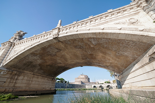 Looking along the River Tiber, under the Ponte Vittorio Emanuele II bridge to the Castel Sant'Angelo.  The Castel was built between 135 AD and 139 AD, as a mausoleum for the emperor Hadrian and his family.