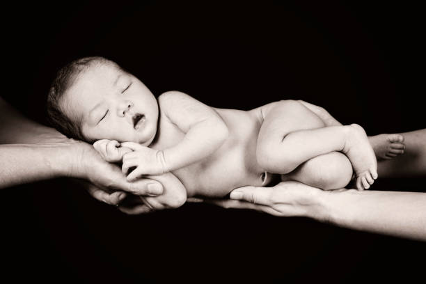 istock Newborn Held in Parents Hands 155095722