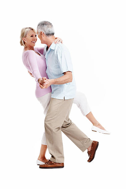 Happy mature couple dancing Full length of happy mature couple dancing on white background middle aged couple dancing stock pictures, royalty-free photos & images