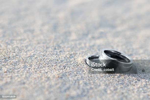 Silver Wedding Rings On The Sand On A Beach Stock Photo - Download Image Now - Wedding Ring, Beach, Color Image
