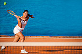 Female tennis player hitting the ball