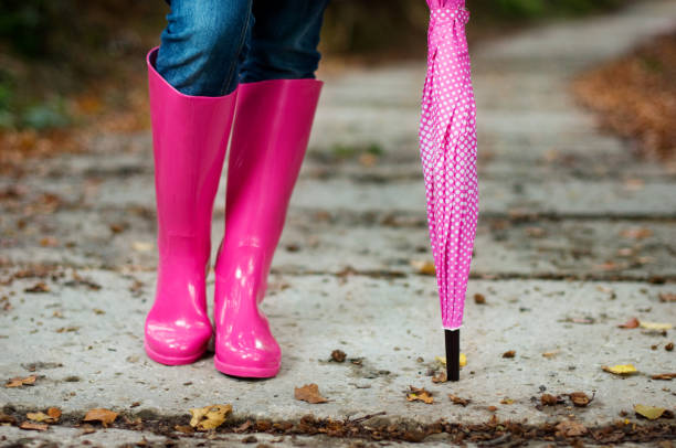 istock Woman with umbrella wearing rubber boots 155095979