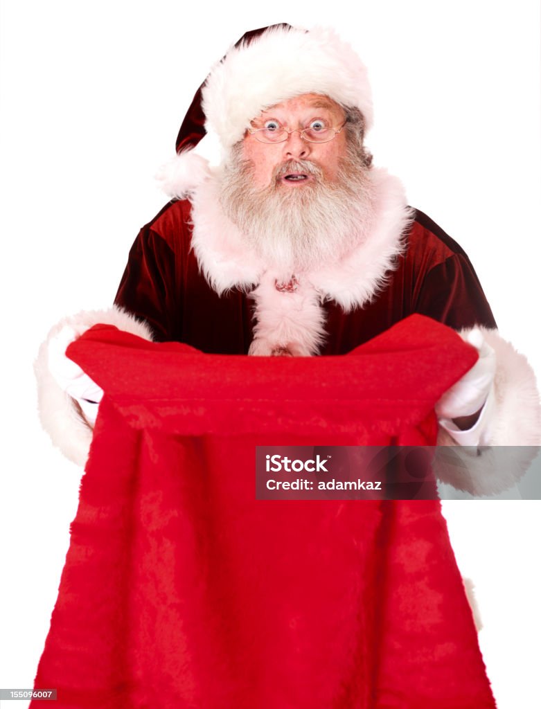 Santa Claus mirando en saco de regalos - Foto de stock de Papá Noel libre de derechos