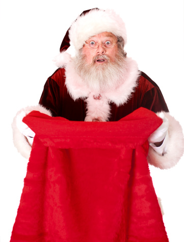 Portrait of a real Santa Claus Smiling looking in his empty bag of presents over shoulder on white background. Room for copy space. Merry Christmas!