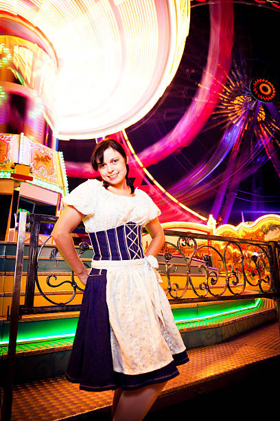 young woman standing next to brightly colored carousel