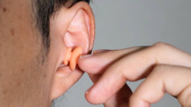 istock Close-up of a man wearing earplugs 1550965314