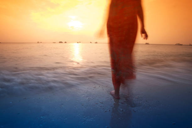Girl on the beach watching sunset.Using orange and blue graduated filters when shooting this photo.