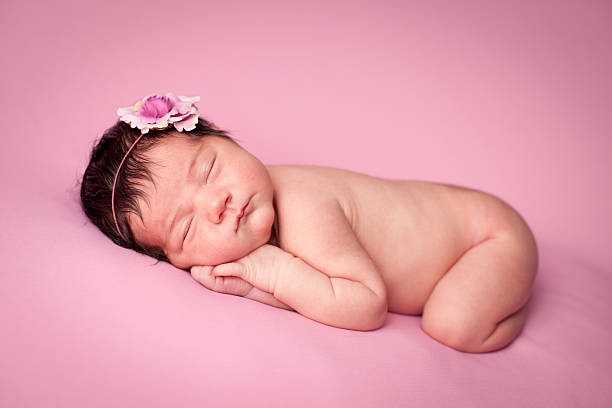 istock Sleeping Newborn Baby Girl on Pink Background With Copy Space 155097236