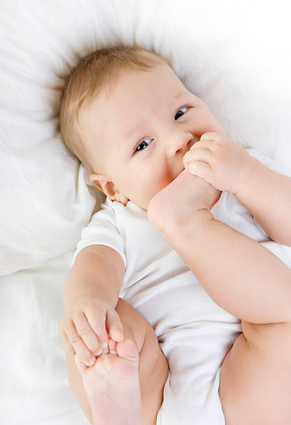 istock Happy Child playing with his feet 155097423