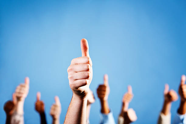 istock Approval, endorsement, agreement: Many thumbs up against blue 155097435
