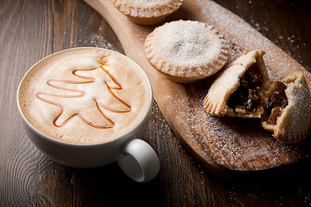 A cappuccino or latte with a caramel christmas tree on top with Mince pies.