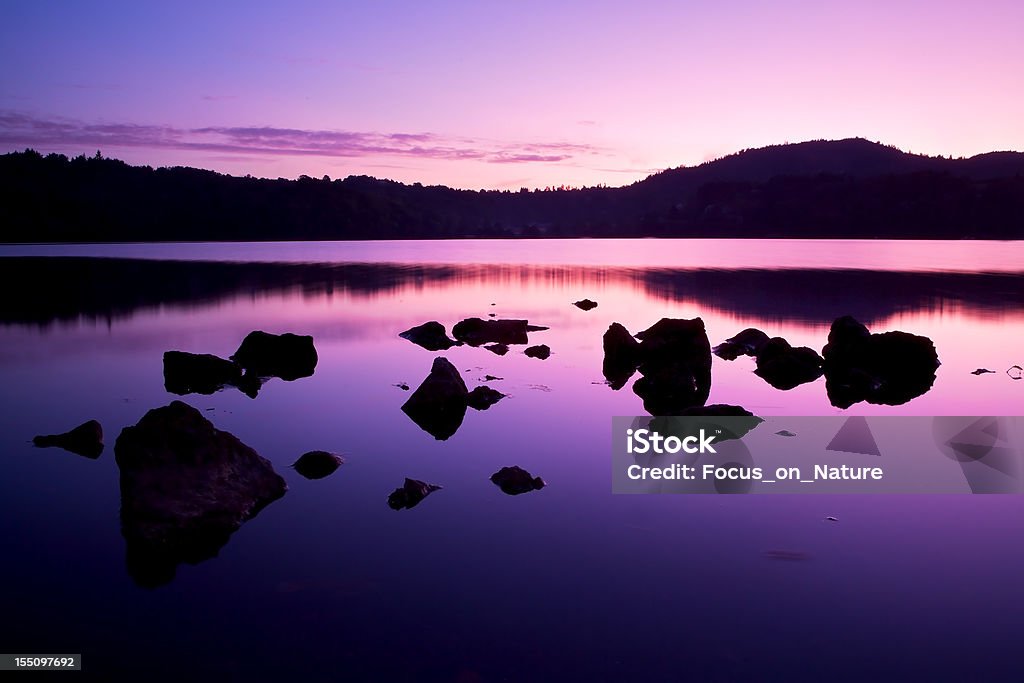 Tranquil lake scene Sunset Sky over Lake and Mountains in the Auvergne, France, Tranquil lake scene Auvergne Stock Photo
