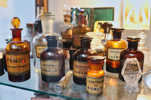 old pharmacy and perfumery bottles of medicines and fruit essences