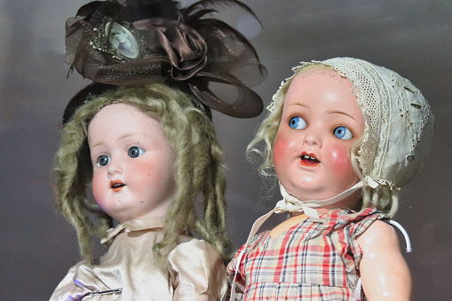 two antique blonde porcelain dolls with a suggestive and scary look