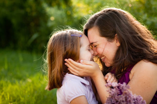 istock Happy Mother and Daughter Smiling While Touching Noses Outside 155098003