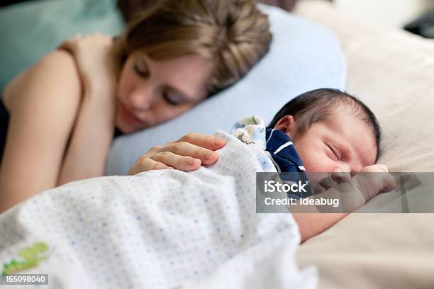 Mother And Newborn Sleeping Peacefully On Bed Together Stock Photo - Download Image Now