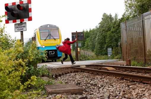 Crazy woman running out in front of moving train