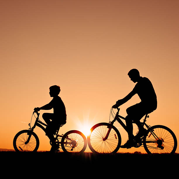 istock Kids riding their bikes during a summer evening - II 155098326