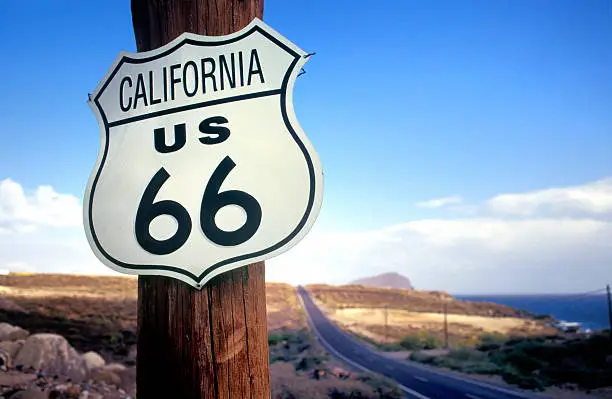 California highway route 66 road sign on wooden pole at clear sky, selective focus on the foreground