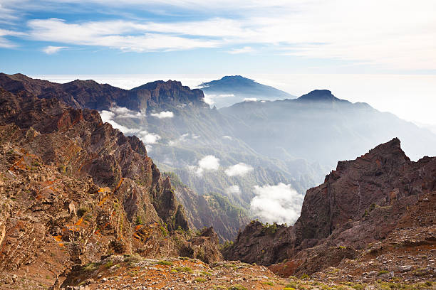 La Palma Volcano Landscape View over the Caldera de Taburiente to the Cumbre Vieja in La Palma, Spain. The evening sun is illuminating the mist further down. la palma canary islands photos stock pictures, royalty-free photos & images