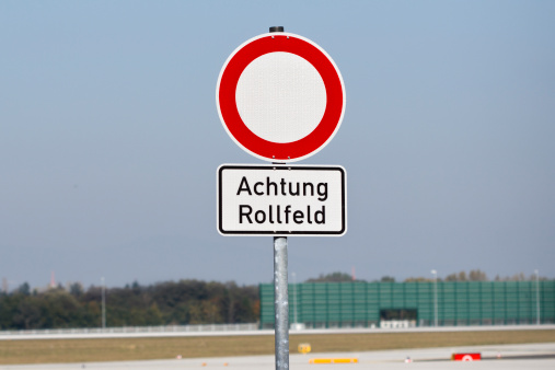 Warning sign at Airport: Achtung Rollfeld.