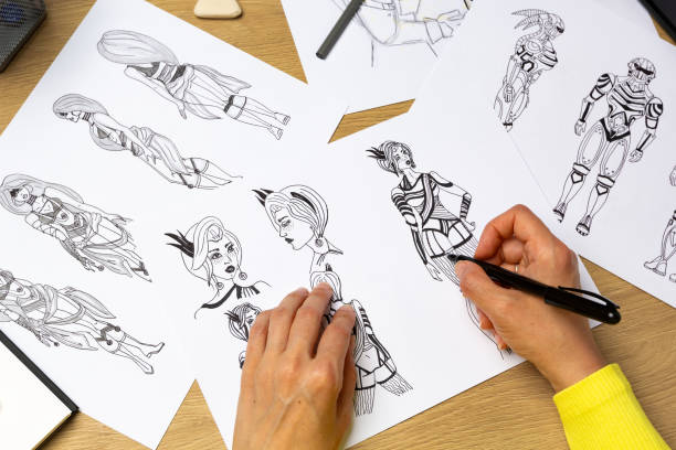 istock The artist draws on paper characters for computer games or comics. 1550985439