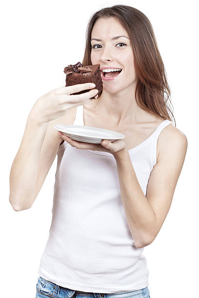 istock Beautiful young woman eating chocolate cake 155098749
