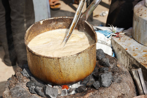 istock Indian tea with milk boiling on open fire 155098972