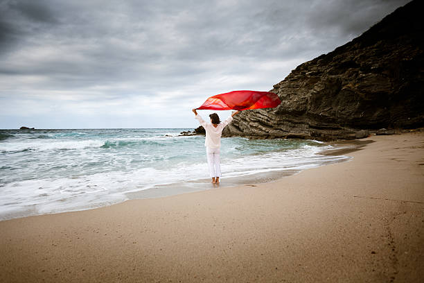 istock Woman on windy beach 155099002