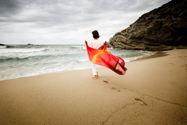 istock Woman on windy beach 155099025