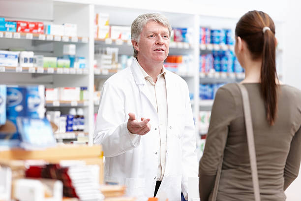 istock Male pharmacist speaking to customer 155099051