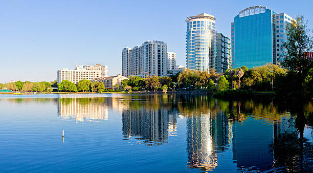 Reflection of Waterfront view of downtown Orlando Lake Eola Orlando Downtown Panoramic View. Reflections. Lake Eola. Early morning. swan at dawn stock pictures, royalty-free photos & images