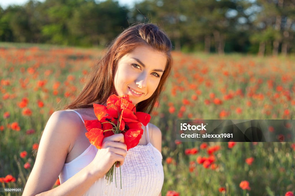 Portret Młoda kobieta z Bukiet wśród czerwone Makowate meadow - Zbiór zdjęć royalty-free (Beztroski)