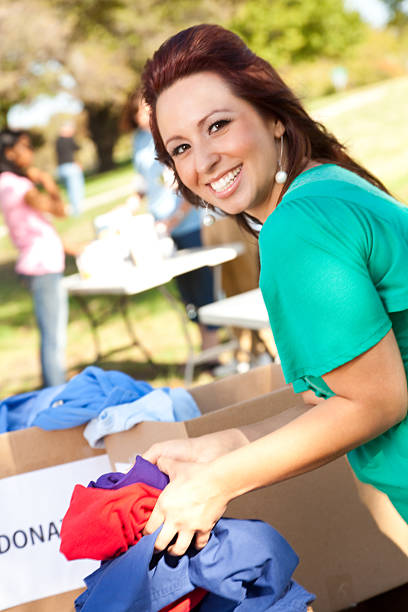 istock Volunteer going through donations boxes at a donation center 155099507