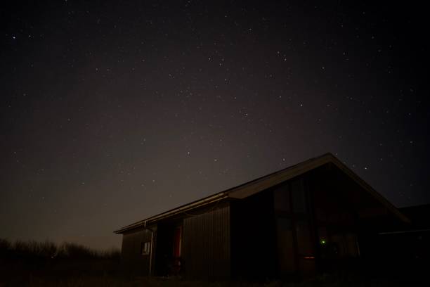 istock Wooden house with starry sky 1550996503