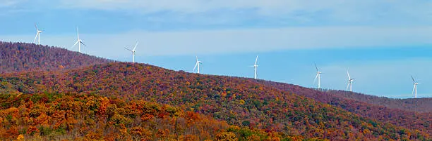 Photo of Wind turbines along a mountain ridge in autumn