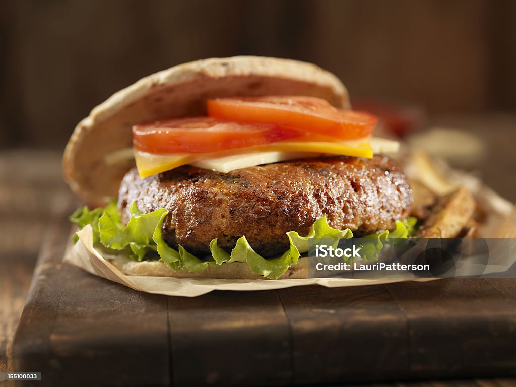 Barbacoa hamburguesa con queso con lechuga y tomate - Foto de stock de Aderezo libre de derechos