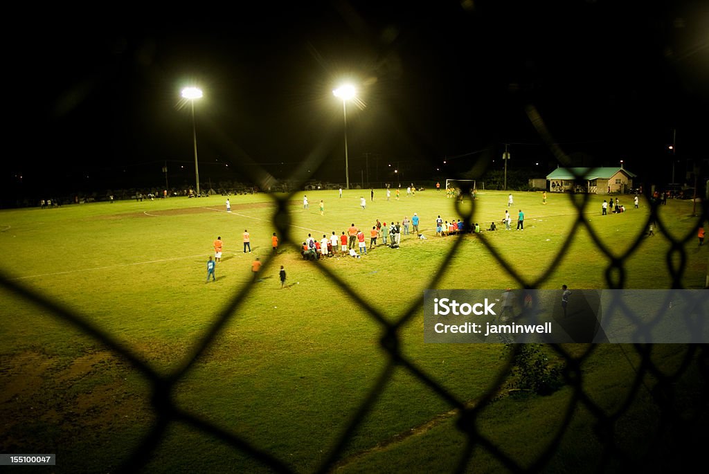 floodlit soccer field through chainlink fence Club Soccer Stock Photo