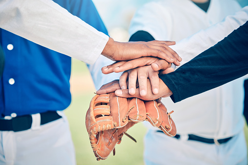 Hands together, baseball team and sport community support of softball group outdoor. Collaboration, teamwork and solidarity of sports people motivation on field for fitness, exercise and workout