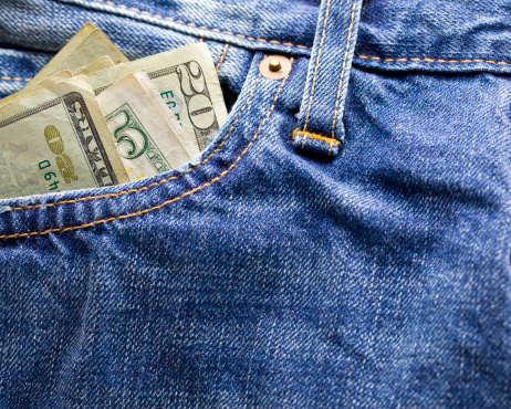 Close up of cash in pants pocket.