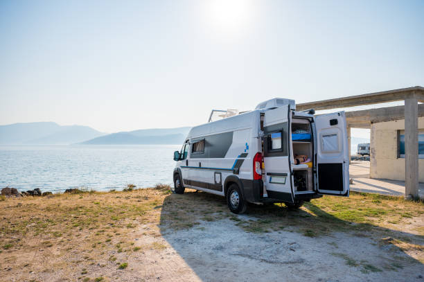 istock Family waking up in a campervan on the beach. 1551011659