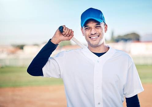 Sports, baseball and man with bat smile ready for playing game, practice and competition on field. Fitness, motivation and male athlete outdoors for exercise, training and workout for sport match